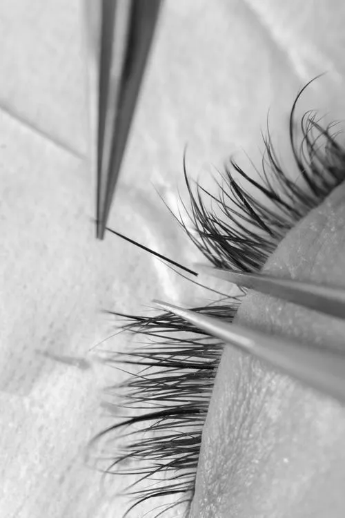 Precision tweezer work during a Russian volume lash appointment